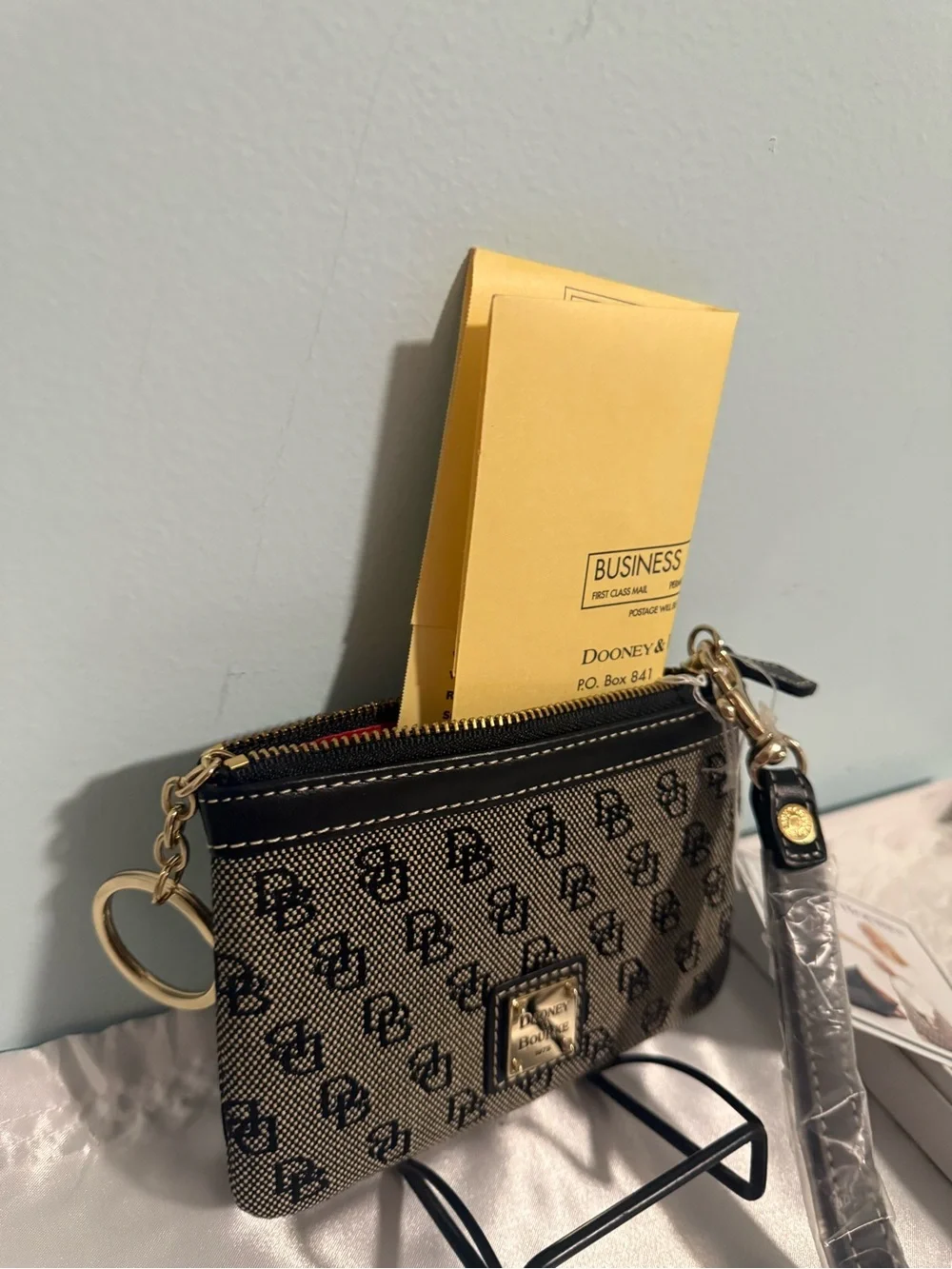 Dooney and Bourke NWT Medium logo wristlet. Comes in a box!